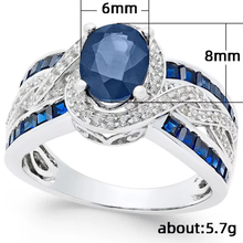 Load image into Gallery viewer, Royal blue zircon ring with white accent stones and a silver band.
