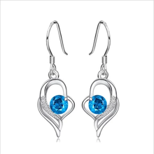 Load image into Gallery viewer, Sterling silver earrings with heart design and blue crystal stones.
