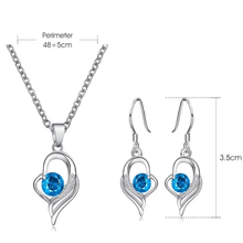 Load image into Gallery viewer, Silver necklace and earring set with blue crystal pendant and hook earrings.
