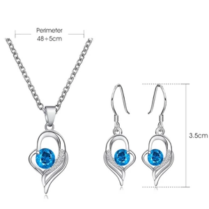 Silver necklace and earring set with blue crystal pendant and hook earrings.