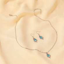 Load image into Gallery viewer, Silver necklace and earrings set with blue faux crystal pendant.
