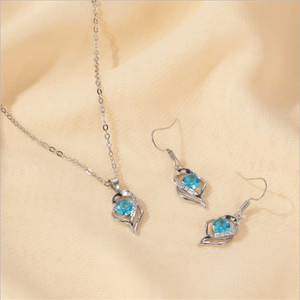 Silver-tone necklace and earring set with blue faux crystal pendant.