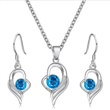 Load image into Gallery viewer, Silver necklace and earrings set with blue crystal heart pendant

