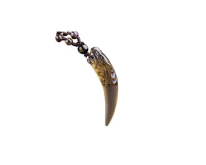 Carved obsidian amulet necklace with gold accents and coffee-colored bead string.