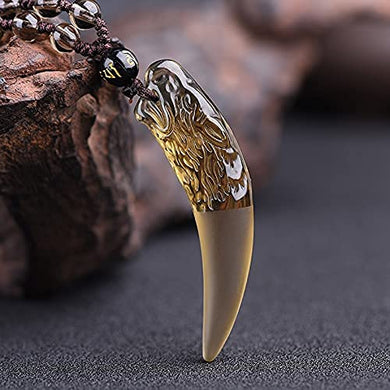 Carved gold obsidian wolf tooth amulet necklace with beaded chain.
