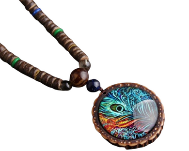 Handmade beaded necklace with a peacock feather pendant. The pendant features blue, red and white colors under glass.
