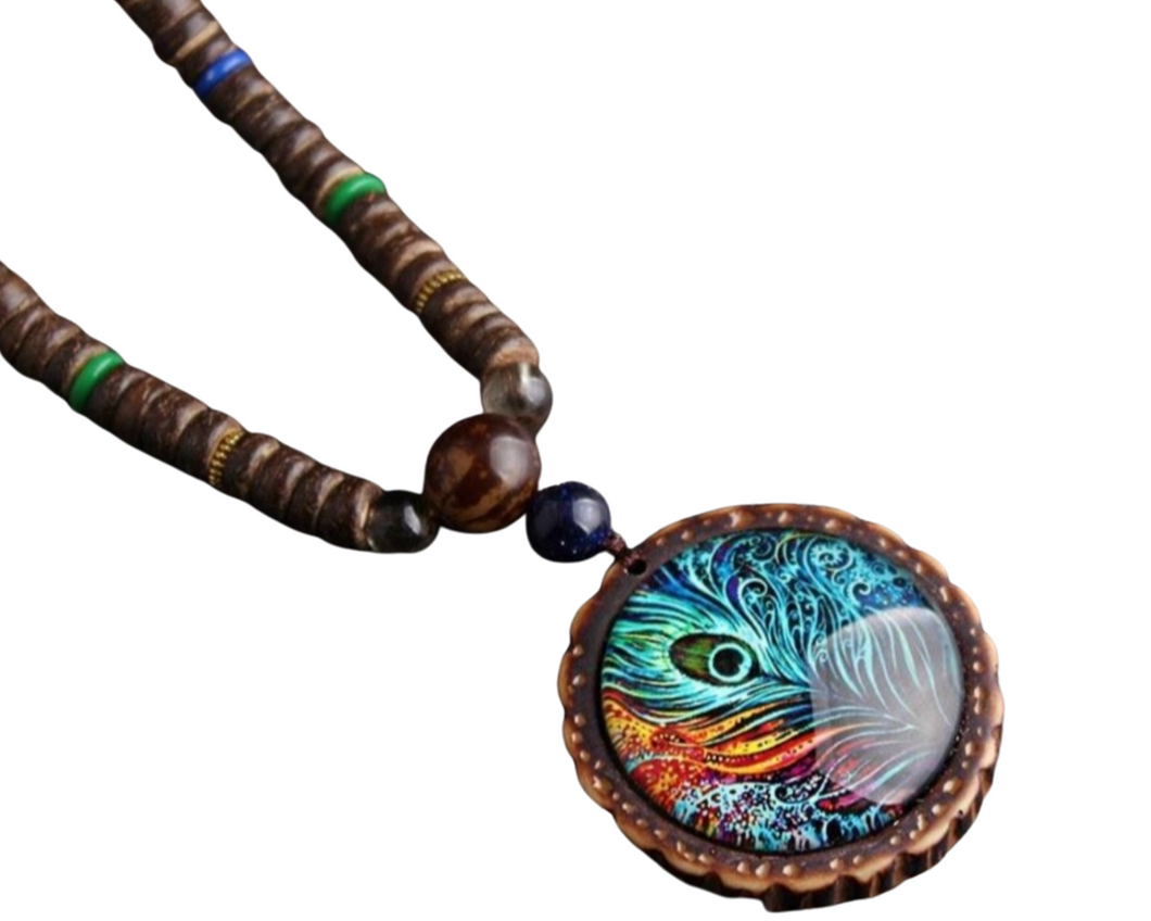 Handmade beaded necklace with a peacock feather pendant. The pendant features blue, red and white colors under glass.