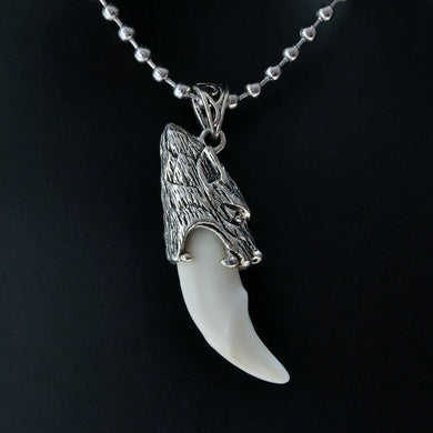Stainless steel wolf tooth pendant necklace, featuring a detailed wolf head and smooth, white tooth.