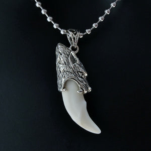 Stainless steel wolf tooth pendant necklace, featuring a detailed wolf head and smooth, white tooth.